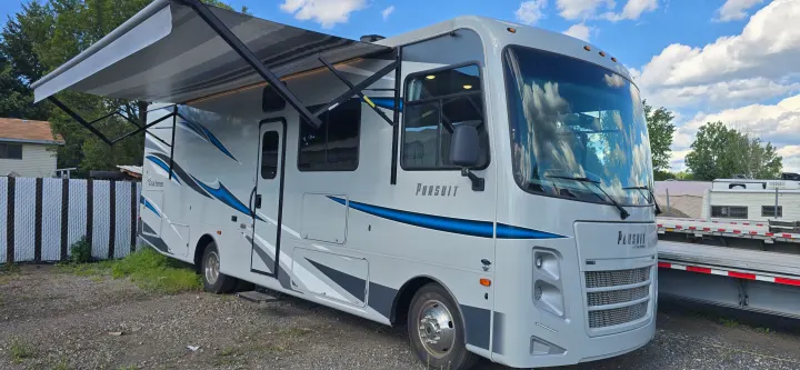 Coachmen Pursuit with its power awning extended