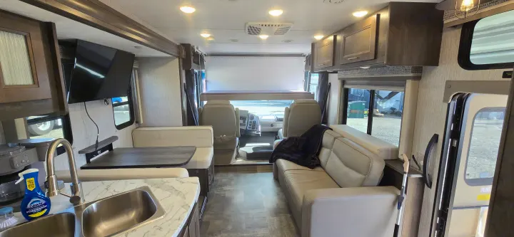 Coachmen Pursuit interior salon with sofa and overhead storage